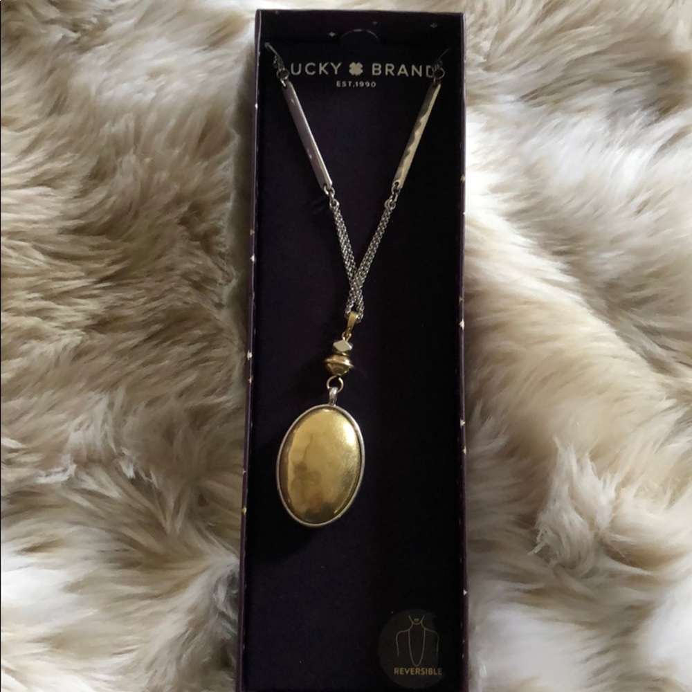 Brand new Reversible silver/gold pendant